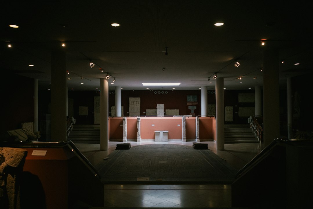 Interior of a modern television studio set with lighting rigs and a news desk