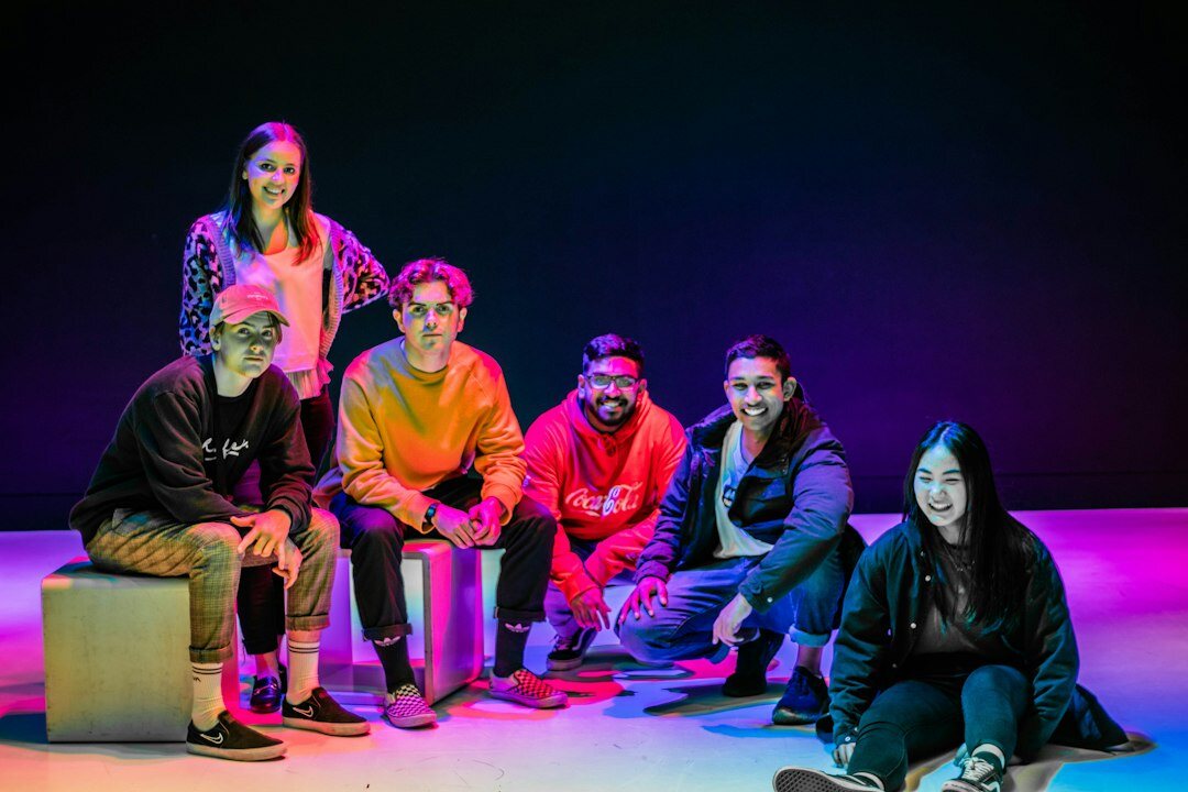 Team of broadcast studio production professionals standing together in a TV studio