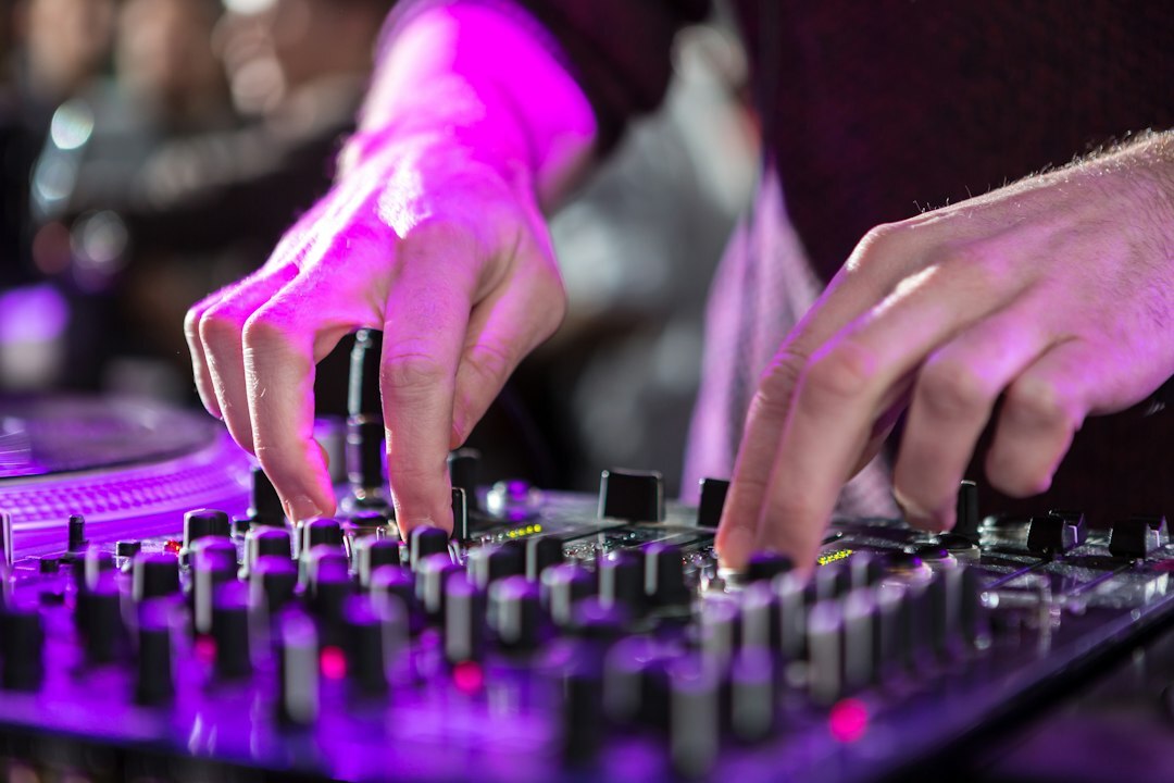 Audio mixing console with illuminated sliders in a broadcast control room