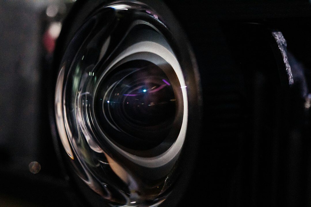 Close-up of a professional television camera lens with lighting reflections